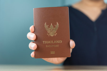 Man hand holding Thailand passport, travel concept.の写真素材