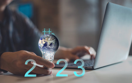 Earth globe inside an LED light bulb in 2023 with solar cell energy, Happy New Year 2023, green...