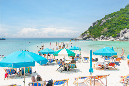 11.03.2023, Thailand, Koh Nang Yuan. People are relaxing on sun loungers under umbrellas on the seaside. Summertime off. Beach time.のeditorial素材