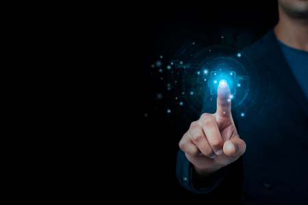 A businessman's hand is gesturing at a blurry blue backdrop with an abstract glowing polygonal...