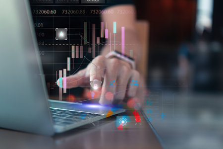 Business professional analyzing complex financial data and stock market trends on a laptop, depicted...