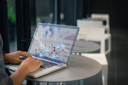 A professional analyzes complex data charts on a laptop in a sleek office environment, showcasing...