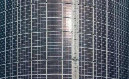 Detailed view of a curved surface covered with modern solar panels, showcasing renewable energy...