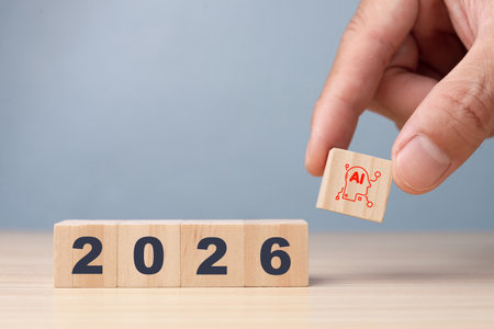 Hand placing an AI wooden cube next to year 2026. Conceptualizing future technology trends,...