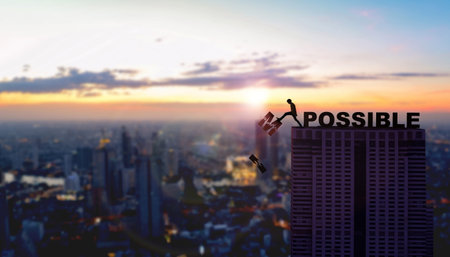 Motivational concept of businessman overcoming obstacles and challenges to achieve success against sunset city background.の写真素材