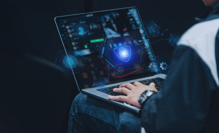 Cybersecurity concept showing a user working on a laptop with a futuristic interface, featuring encryption shields, biometrics, and threat detection icons for data safety.の写真素材