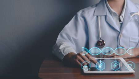 Doctor using a tablet with a digital DNA interface. Concept of medical technology, genetics, and healthcare innovation.の写真素材