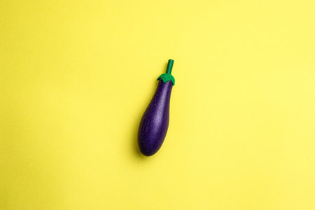 Purple eggplant on a yellow background. Minimal concept.の写真素材