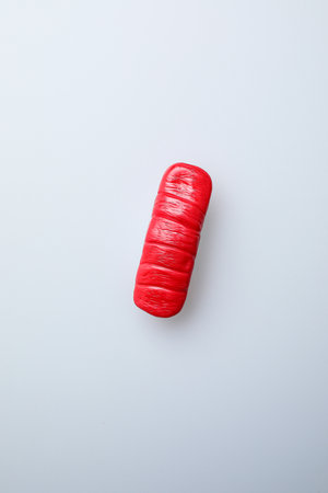 Red condom on a white background. Safe sex concept. Top view.の写真素材