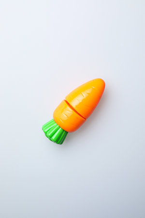 Orange and green plastic toothbrush isolated on white background. Top view.の写真素材