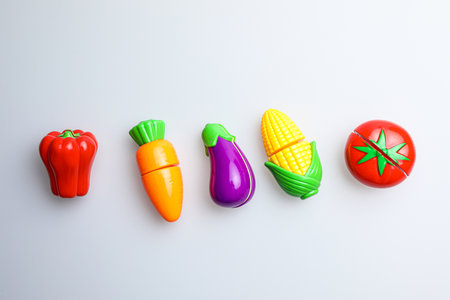 Colorful plastic vegetables on white background, top view, copy spaceの写真素材