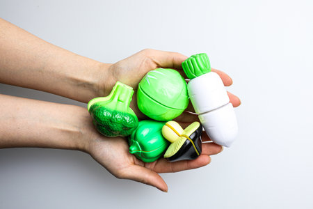 Plastic waste in the hands on a white background. Environmental pollution.の写真素材