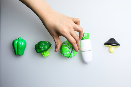 Woman's hand holds a plastic bottle of shampoo on a white backgroundの写真素材