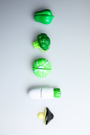 Healthy eating and dieting concept. Top view of green vegetables and pills on white backgroundの写真素材