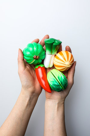Hands holding a lot of colorful plasticine isolated on white backgroundの写真素材
