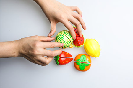 Easter eggs in the hands of a child on a white backgroundの写真素材
