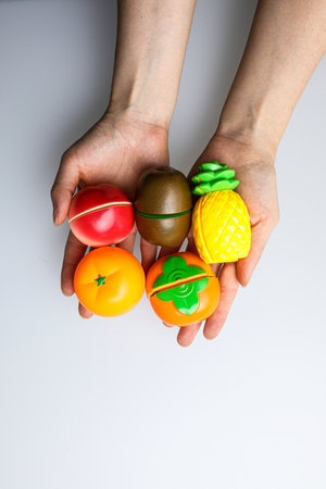 Easter eggs in the hands of a child on a white backgroundの写真素材