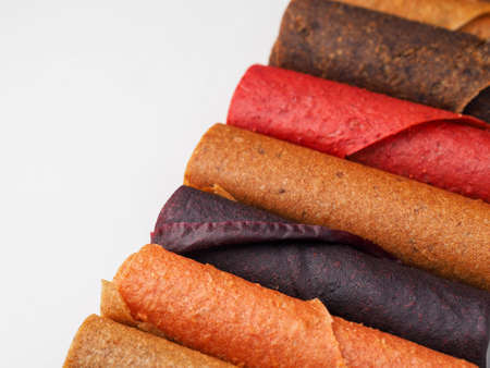Colorful fruit leather rolls on white backgroundの写真素材