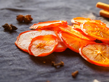 A lot of dried orange persimmon flatlay with cinnamonの写真素材