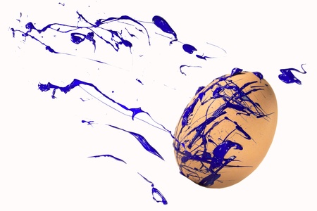 Blue paint sprays on the easter eggの写真素材