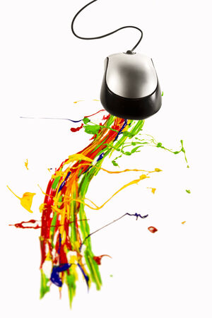 Computer mouse making multicolor paint splashの写真素材