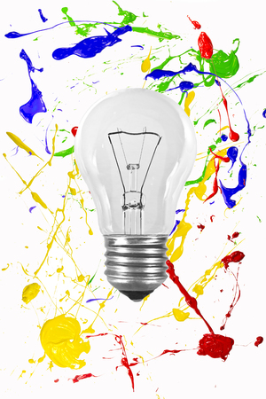 Light bulb on a colorful painted backgroundの写真素材