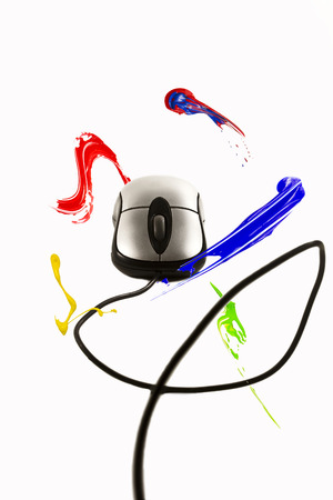 Paint strokes circulating around computer mouseの写真素材
