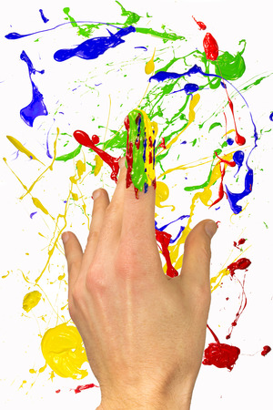 Hand with painted forefinger on colorful backgroundの写真素材