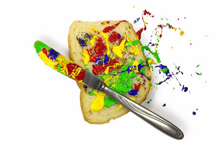 Colorful playfully paint spread on the breadの写真素材