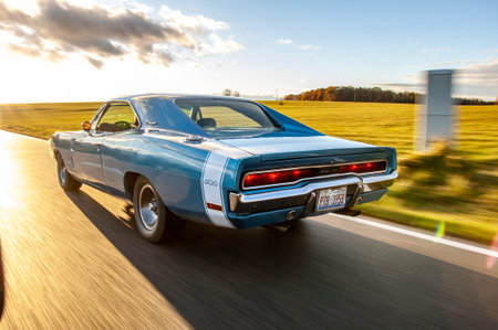 Classic american car on the road at sunset, motion blur. Dodge Charger 500 1970のeditorial素材