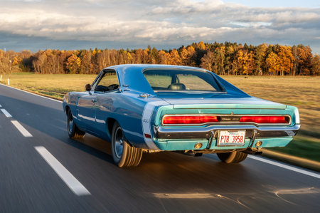 Classic american car on the road at sunset, motion blur. Dodge Charger 500 1970のeditorial素材