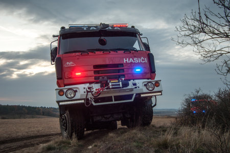 Fire truck on the field at sunset.
