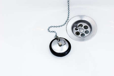 a plug and a discharge in the wite sinkの写真素材