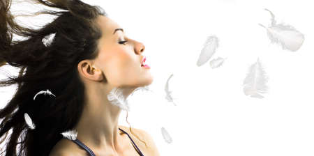 relax girl and feather on the white backgroundの写真素材