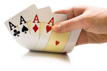 a man's hand holding new playing cards