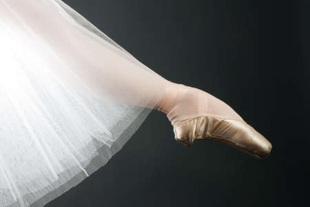 legs in ballet shoes on a black backgroundeの写真素材