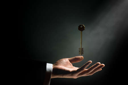 a man pointing to the gold keyの写真素材
