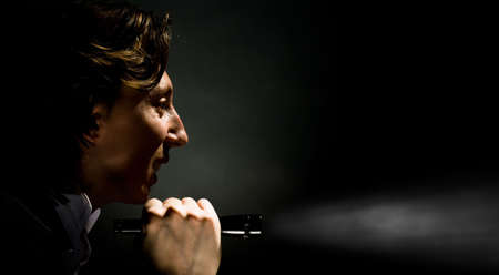 man with the flash-light on black backgroundの写真素材