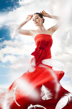 beautiful young woman in red long dressの写真素材