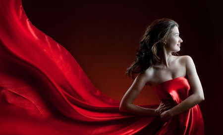 beautiful young woman in red long dressの写真素材