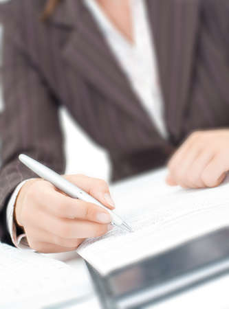 a secretaryl writing a letter on the paperの写真素材