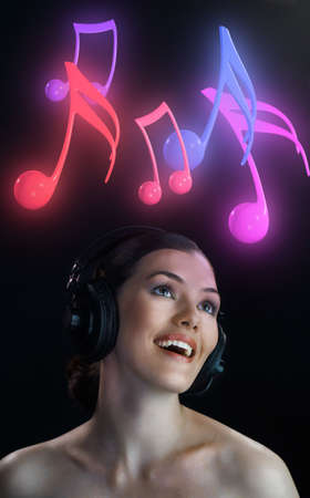 girl with headphones on the black backgroundの写真素材