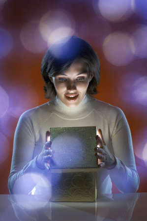 a beauty young girl with christmas giftの写真素材