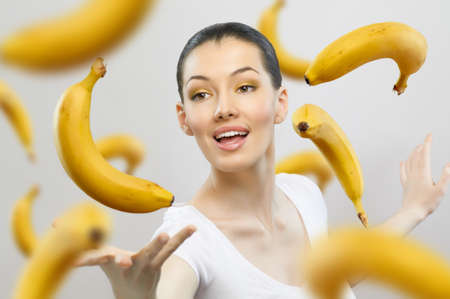 a girl with a ripe yellow bananaの写真素材