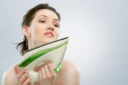 beautiful girl with an ironの写真素材