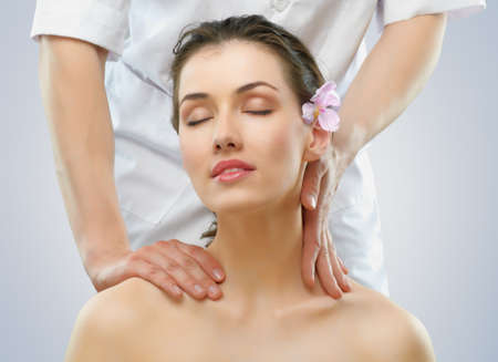 a young beautiful girl is being massagedの写真素材