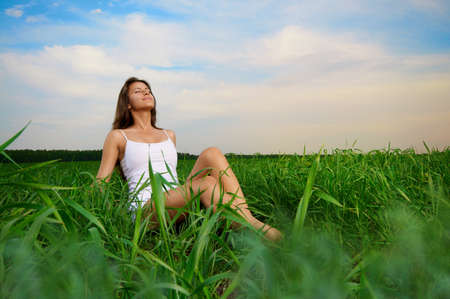 beautiful girl relaxing in a fieldの写真素材