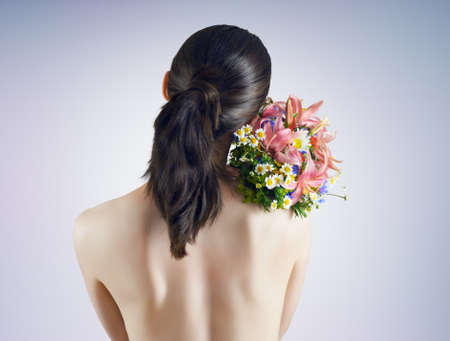 Girl with flowers standing behind