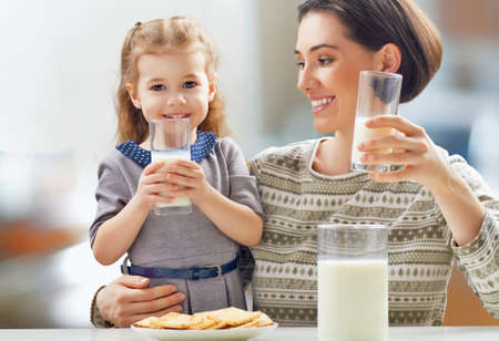 girl drinking milk at the kitchen