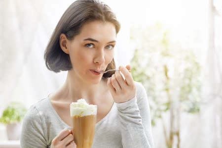 Woman with an aromatic coffee in handsの写真素材